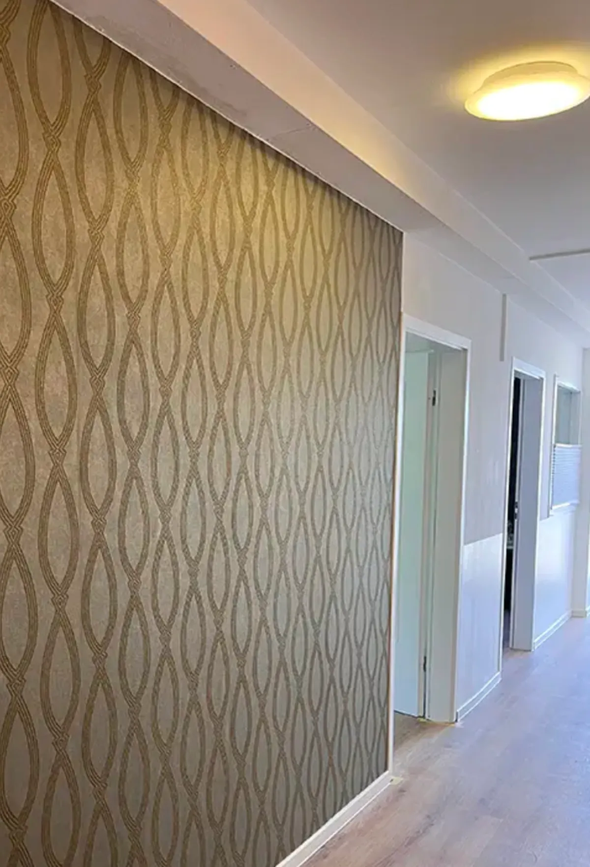 Flur mit eleganter Mustertapete in Gold